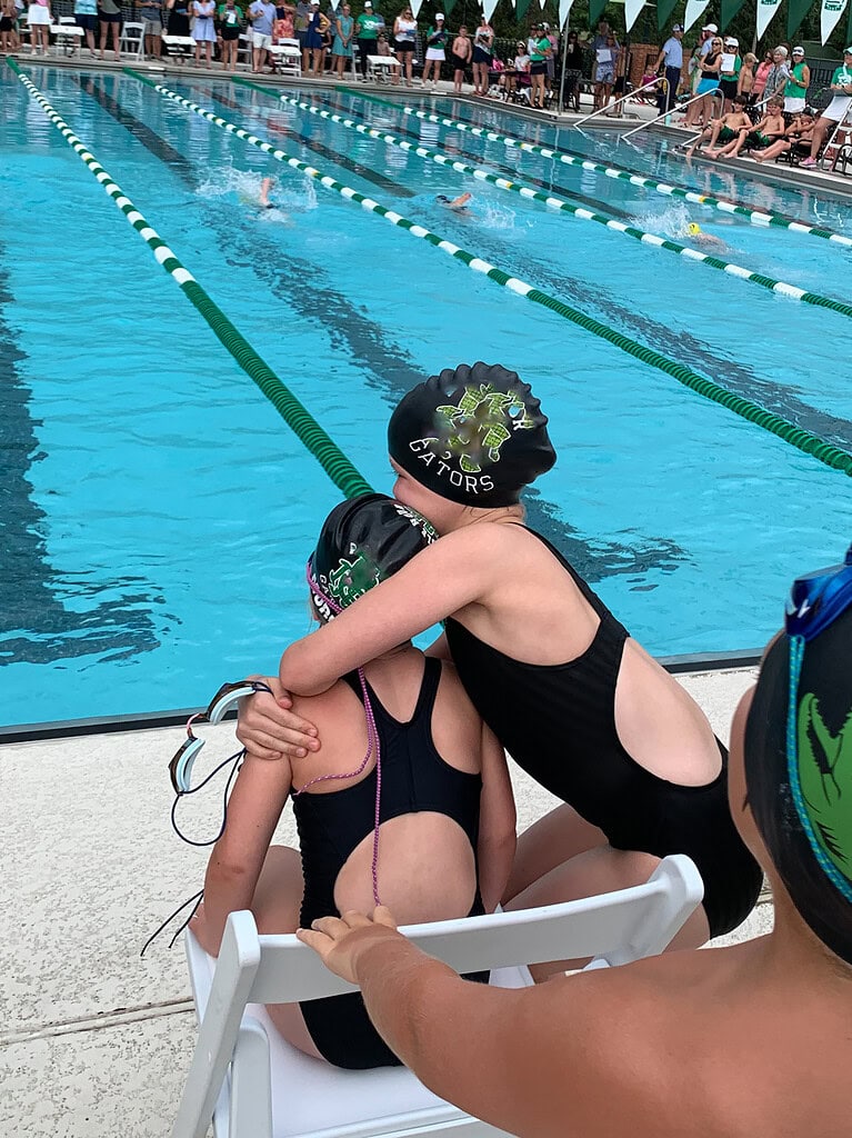 Sisters participating in a swim meet.
