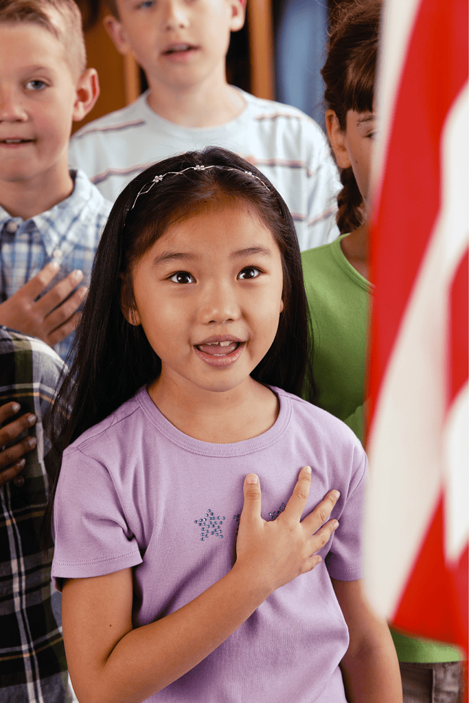 A girl stays that Pledge of Allegiance. 